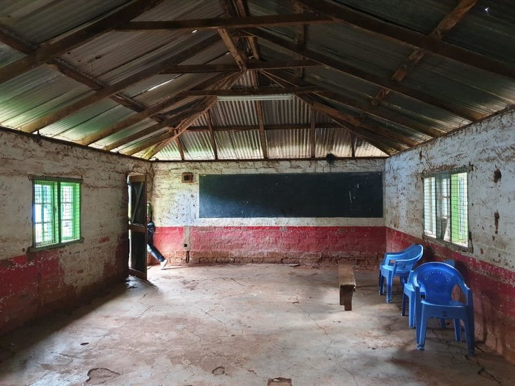 Figure 9: Interior of class room, notice barbed wire along the roof. Mweru High school.
